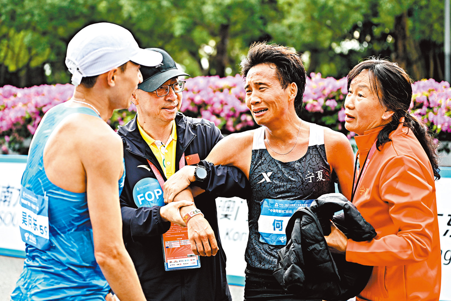 ●何傑（右二）奪冠後激動落淚。中新社