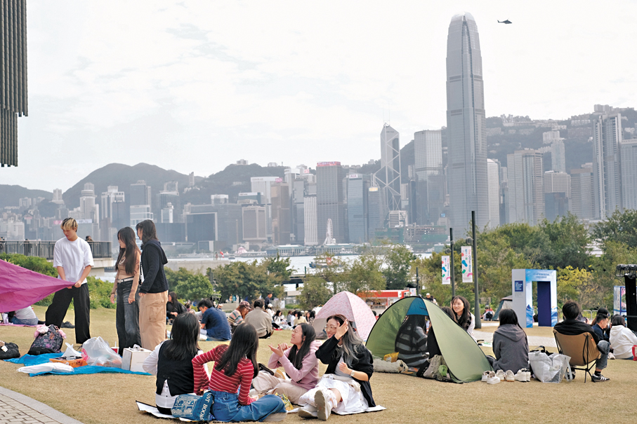 ●西九文化區草坪昨午已現人群，有人鋪上野餐墊、搭起帳篷，擺放輕食與飲品，播放音樂，氣氛熱鬧。 香港文匯報記者涂穴 攝