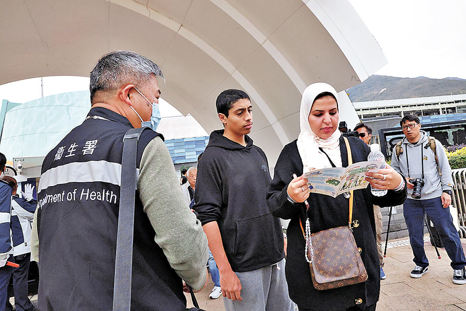 ●控煙酒辦人員昨日到海洋公園入口附近派發單張，向市民及遊客介紹新一階段控煙措施。香港文匯報記者萬霜靈  攝