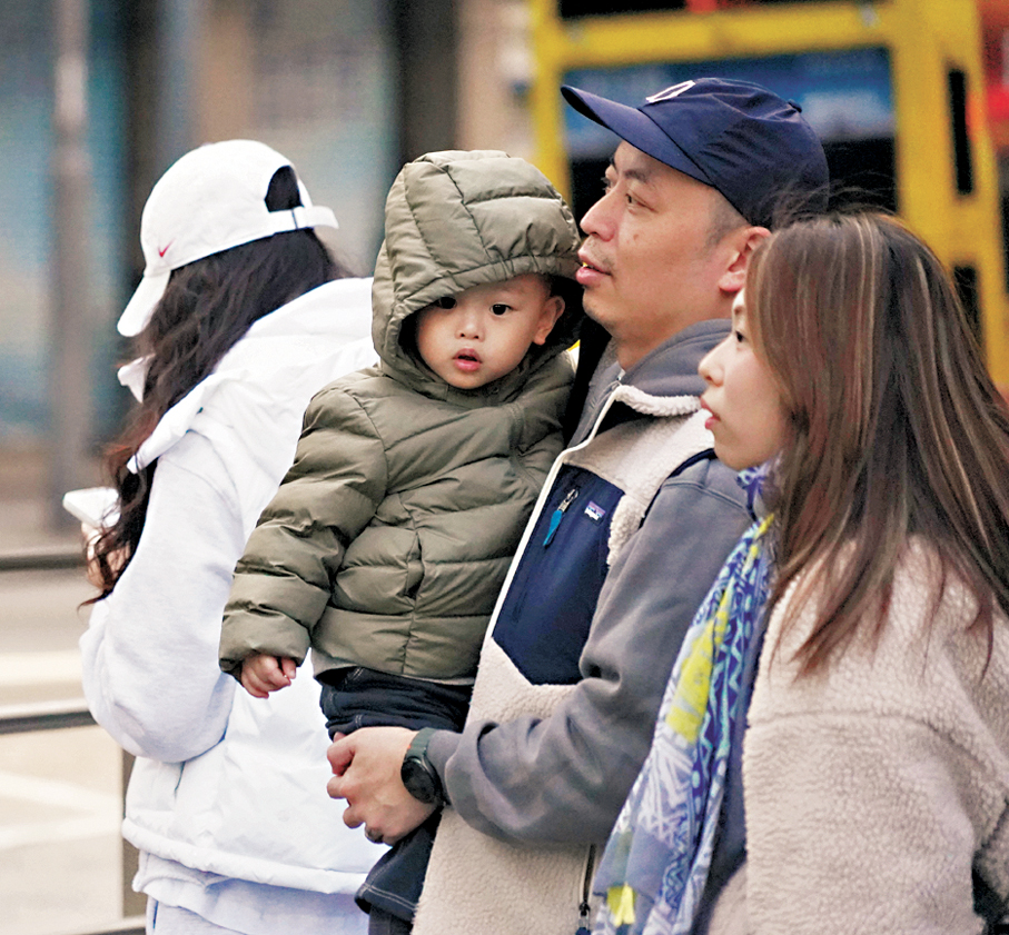 ●小孩出行添衣保暖。香港文匯報記者曾興偉  攝