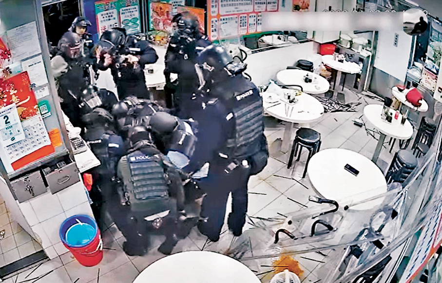 ●警員內外夾擊衝入店內，發射胡椒水將女食客制服拘捕。視頻截圖