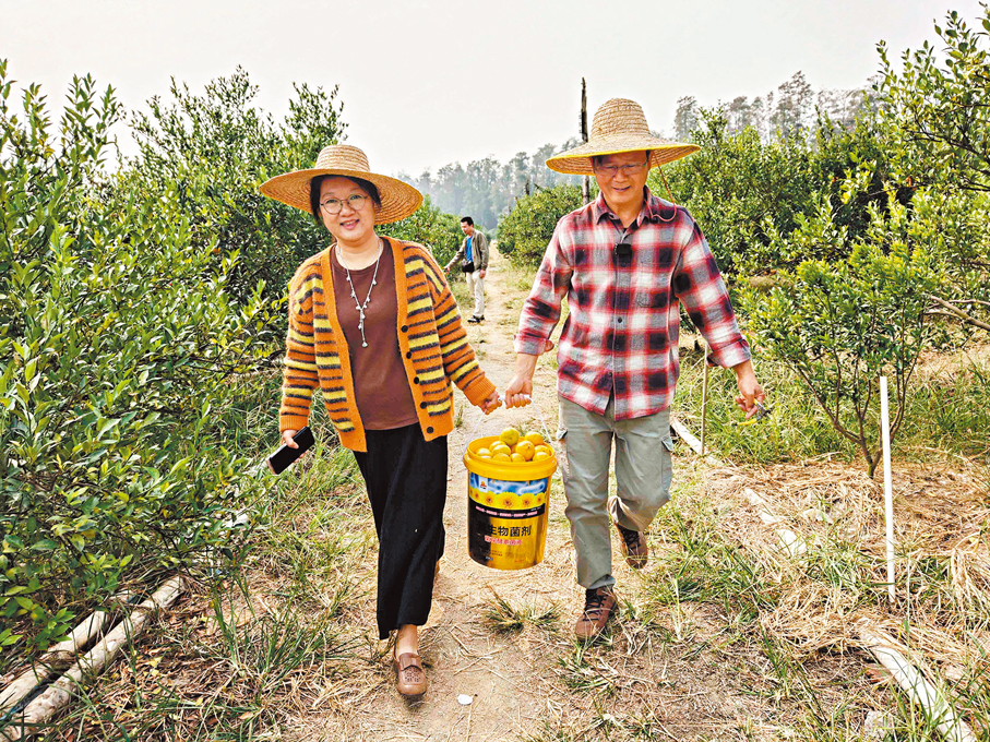 容耀庭和妻子一起把客戶挑選的果實拎回工場。