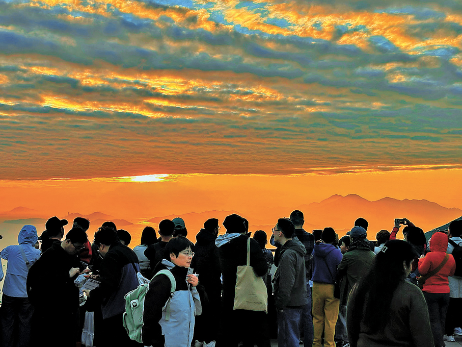 ●傍晚在山頂廣場看晚霞的遊人。 作者供圖