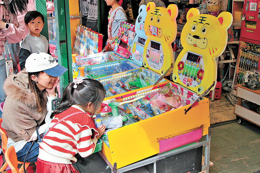 ●小孩在攤檔玩遊戲。香港文匯報記者黃艾力  攝