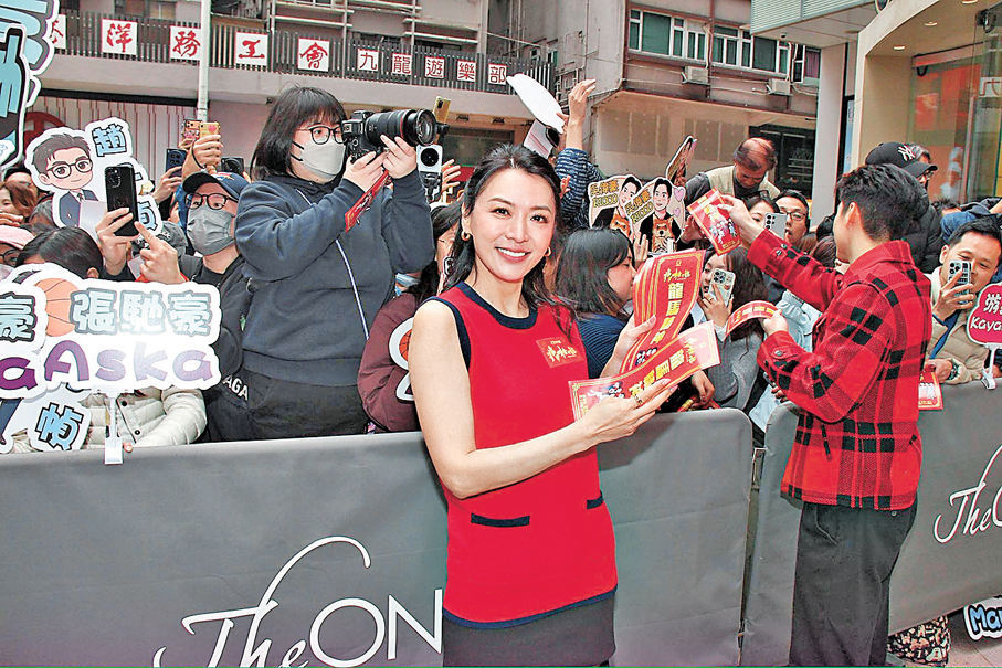 ●一眾演員向圍觀市民派揮春慶祝新年。  香港文匯報記者達里 攝