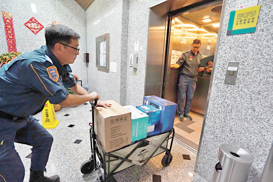 ●關永森和李嘉輝運送安居包。 香港文匯報記者曾興偉  攝
