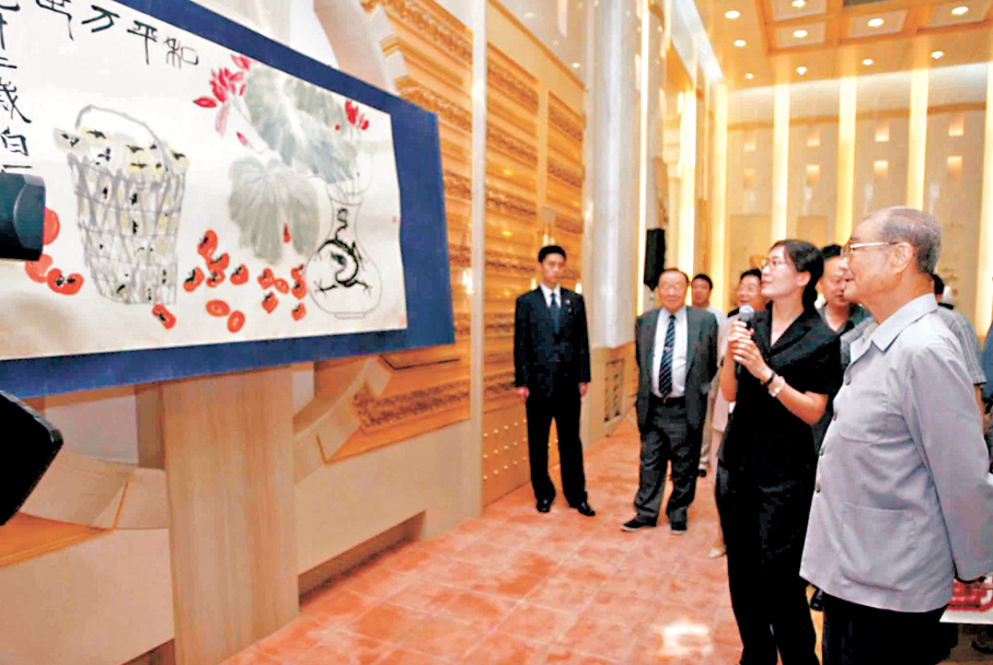 ●2004年6月26日，中央文獻出版社在北京人民大會堂台灣廳舉行《西花廳珍藏書畫集》出版座談會。宋平與眾人一同觀賞齊白石所作的「和平萬世圖」等書畫。 資料圖片