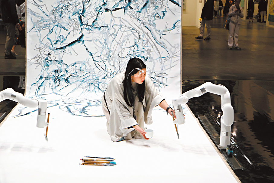 ●鍾愫君在展區與機械臂共創。 記者雨竹 攝