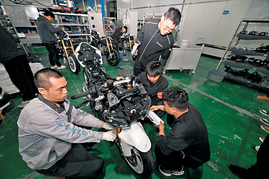 ●張雪機車的技術人員與工人正在精密組裝摩托車車架與發動機。香港文匯報重慶傳真