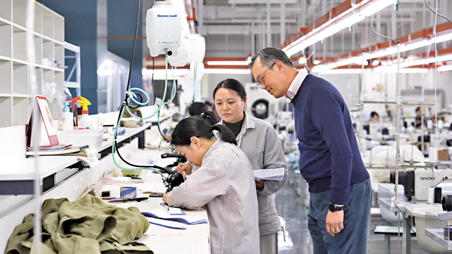 ●張宗琪在奉化工廠中與工人交流。