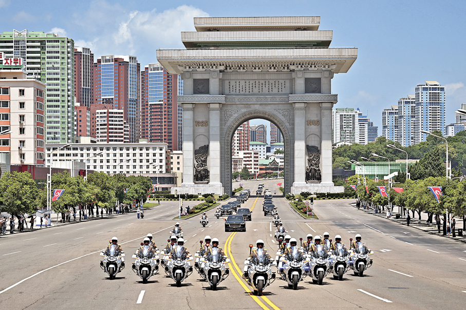 ●當地時間6月8日中午，中共中央總書記、國家主席習近平乘專機抵達平壤。這是車隊駛過凱旋門。 新華社