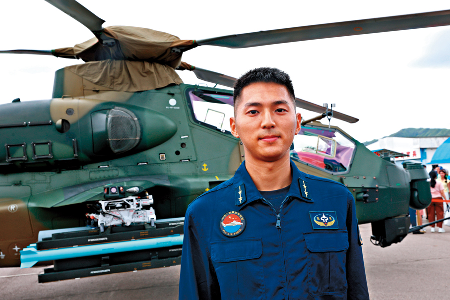 ●駐香港部隊空軍中尉張世傑介紹直升機知識。 香港文匯報記者萬霜靈  攝