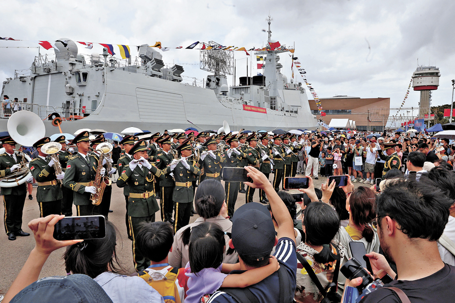即席演奏●軍樂隊在岸邊演奏，吸引參觀者圍觀。  香港文匯報記者萬霜靈  攝