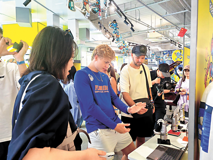 ●外國遊客在機器人6S店體驗猜拳機器人。