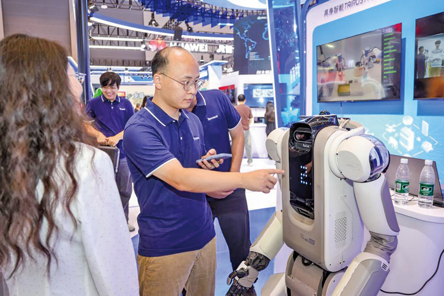 ●在重慶舉行的2025世界智能產業博覽會現場，工作人員向觀眾介紹養老機器人「小五」。 （新華社）
