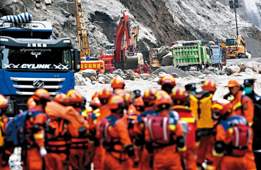 ●大型車輛、機械設備可通過216國道進入受災核心區，開展深層次搜救。圖為挖掘機等搶險機械在開展道路搶通作業。 中新社