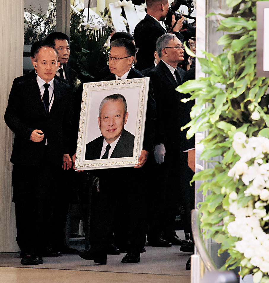 ●董建華長子董立均手捧父親遺照步出靈堂。中新社