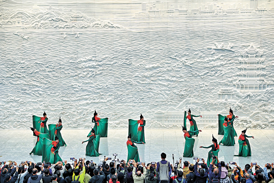 ●10月2日，湖北武漢市歌舞演員在武昌站東廣場站內白玉浮雕牆前表演舞蹈《橘頌》。 中新社